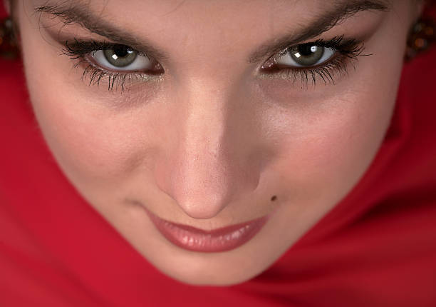 Young female with red bow tied into her dark hair