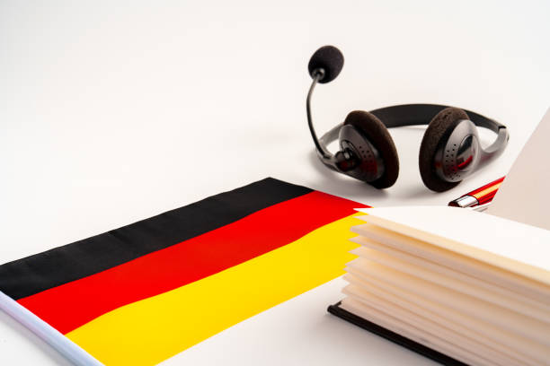 istock Notepad with German flag and headphones on white background. German language audio courses educational concept 1768194035