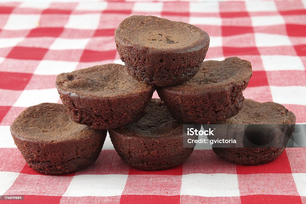 Small brownies Small chocolate bite sized brownies on red checkered tablecloth Brownie Stock Photo