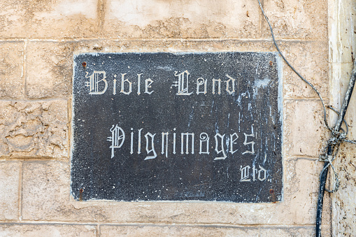Nazareth, Israel, September 17, 2023 : Marble plaque on the wall with the inscription Bible Land Pilgrimages in Nazareth old city in northern Israel