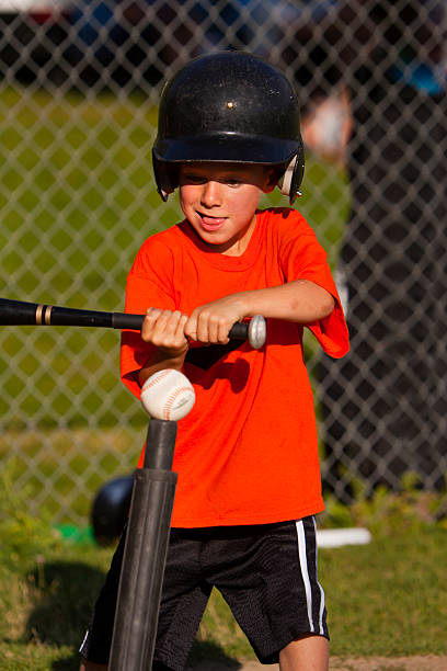 istock Boy swings bat at tee-ball 176820090