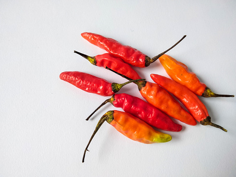 Bunch of red, green and yellow ripe hot peppers.