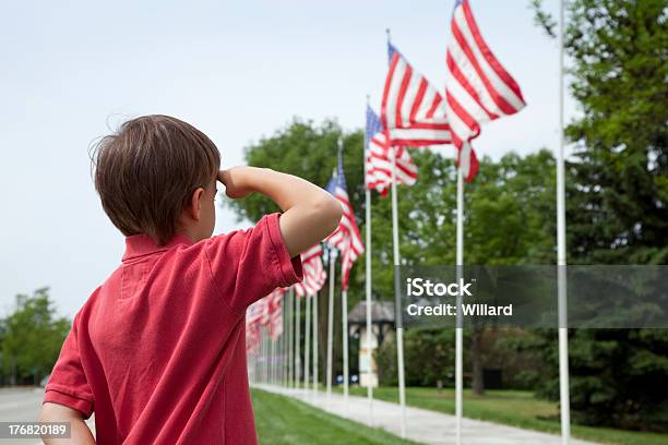 Young Boy Salutes Flags Of Memorial Day Display Stock Photo - Download Image Now - Saluting, US Memorial Day, Child