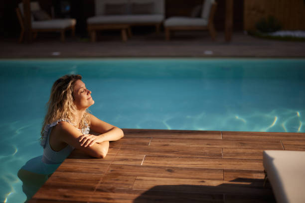 istock Smiling woman spending her summer day in the pool. 1768202720