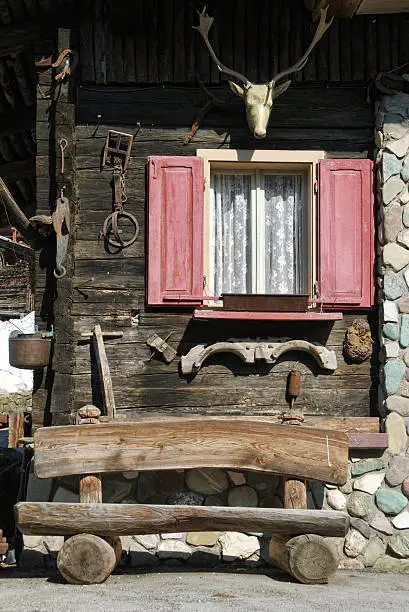 "Typical wooden house external decorations of an alpine tyrolish-style house in Sappada (Belluno, Veneto, Italy) on Dolomites alps."