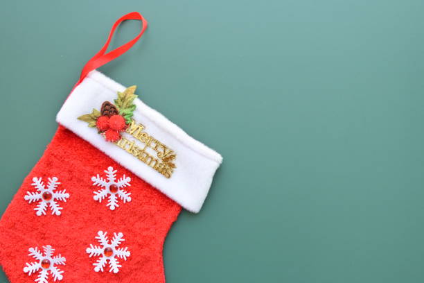 istock red wool winter sock on green background, christmas decoration 1768212776
