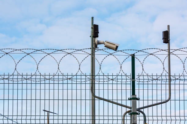istock CCTV camera, motion sensors and spiral protective barrier. Facility security complex. 1768215405
