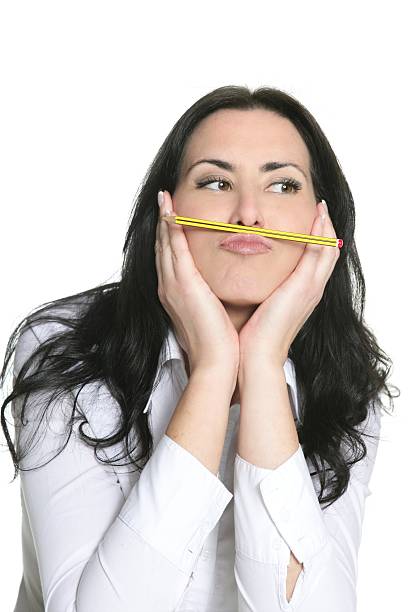 istock Brunette woman thinking with pencil 176821927