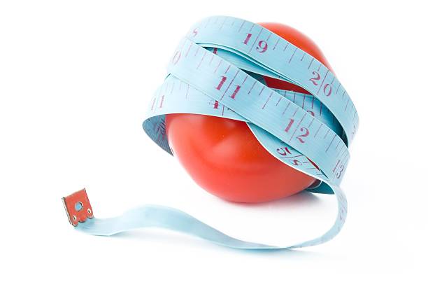 istock tomato with waist measured 176822247