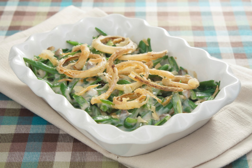 Green bean casserole - a traditional Thanksgiving side dish. Green beans mixed with cream of mushroom soup and topped with french-fried onions.