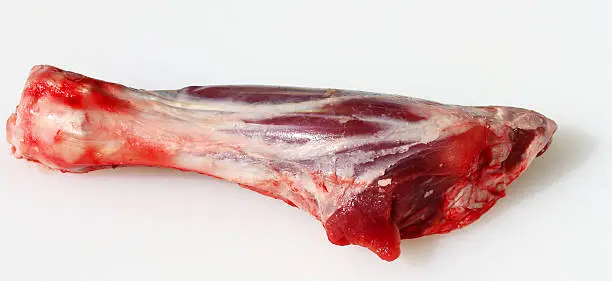 A raw lamb shank prepared ready for cooking.