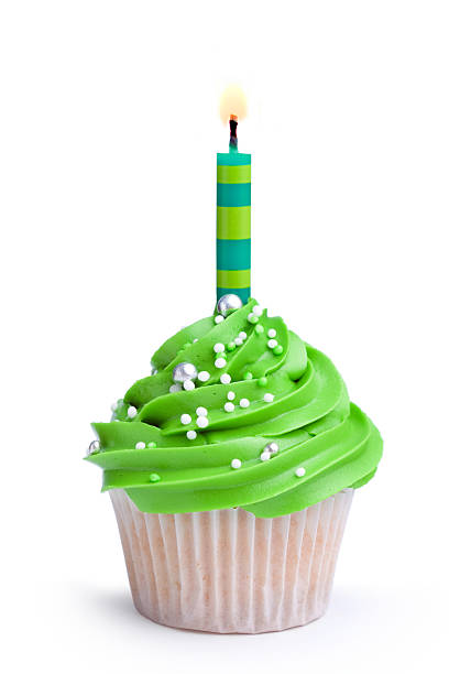 Birthday cupcake Cupcake decorated with green frosting and a single candlePlease see my portfolio for lots more cupcakes - cupcake stock pictures, royalty-free photos & images