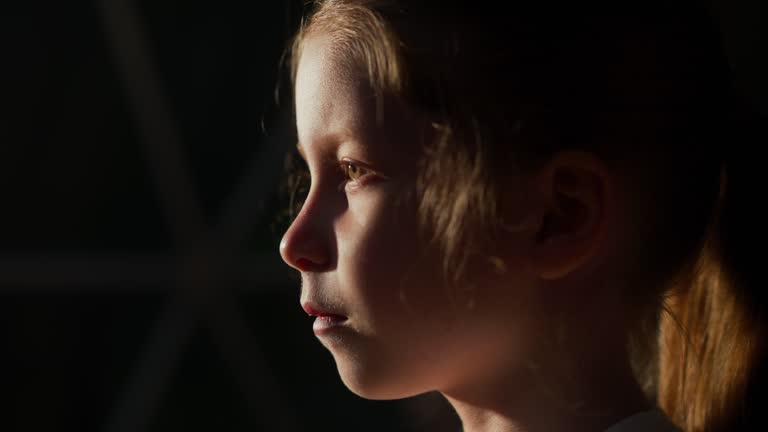 Calm child by window at night glamping closeup