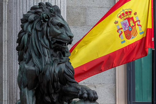 Madrid, Spain - October 31, 2023: The Congress of Deputies is decorated to receive the Kings of Spain and the Princess of Asturias on their birthday.  The lion of the courts next to the flag of Spain.