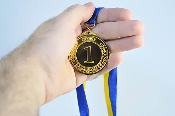 Hand holding beautiful golden (medal) trophy