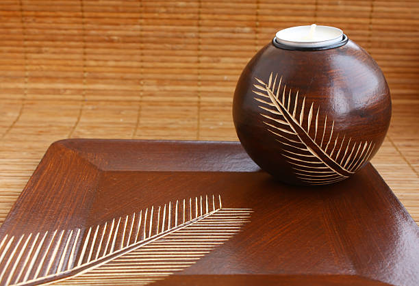 istock candle within candlestick on wood tray 176823590