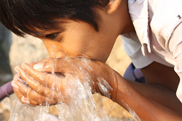 istock A person drinking water with their hands 176823603