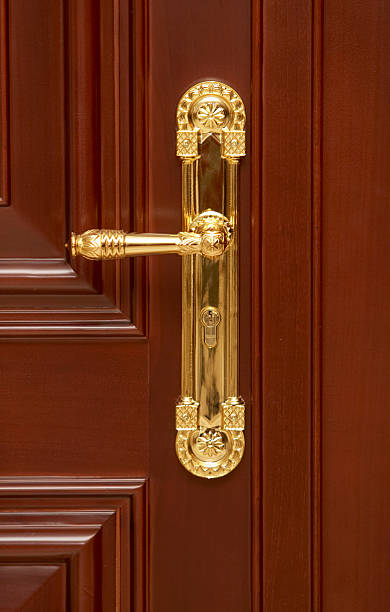 istock wooden door gold handle architecture detail 176823717