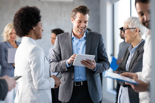 istock Group of business colleagues communicating in a hallway. 1768244050