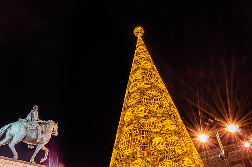 Night view of Puerta del Sol central square in Madrid, Spain, with Christmas decorations