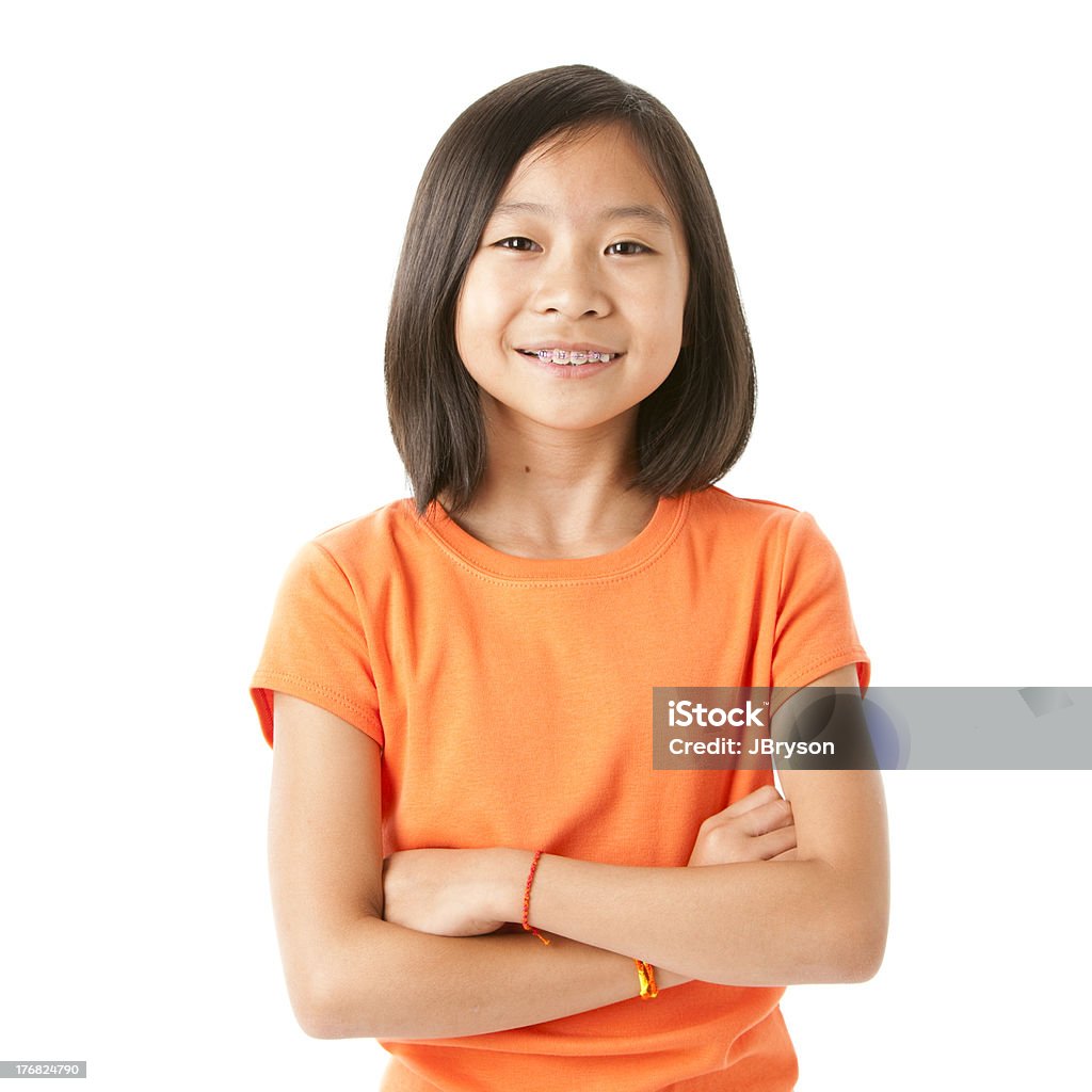 Smiling Asian Little Girl A pretty nine-year old Asian girl shows off her braces with a big smile Child Stock Photo