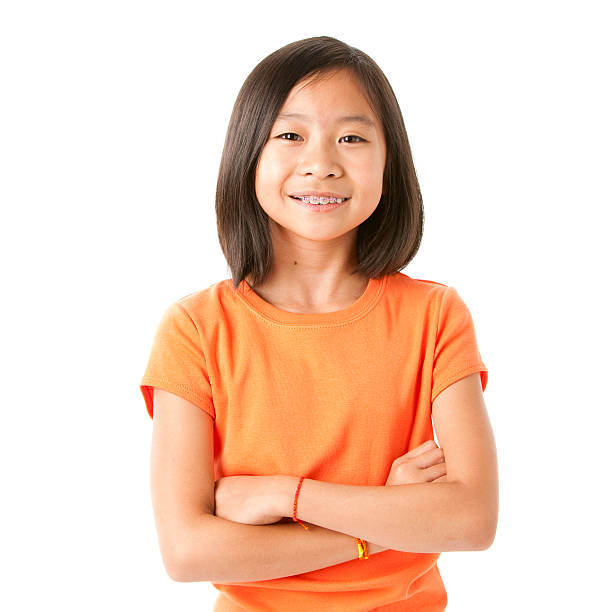 Smiling Asian Little Girl A pretty nine-year old Asian girl shows off her braces with a big smile smiling kids on white stock pictures, royalty-free photos & images