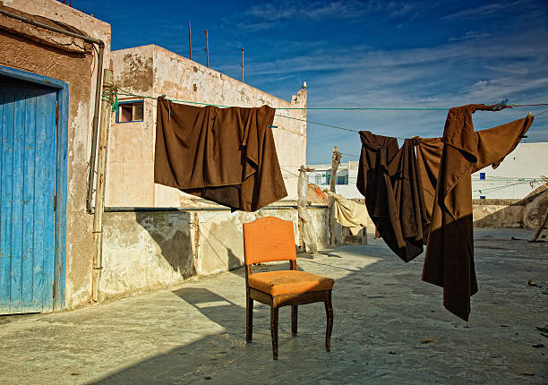 An image where the point of view is deceptive. Really the chair is in a wall orientated towards the sky.