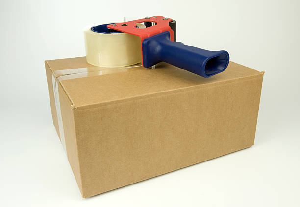 istock Cardboard Box with a tape dispenser 176825053