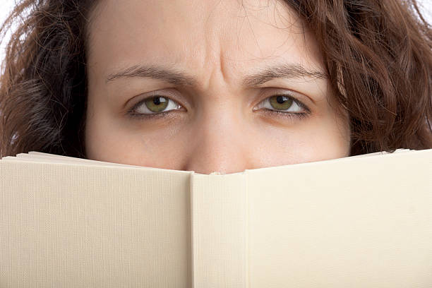 istock Sceptical Girl with Book 176825089