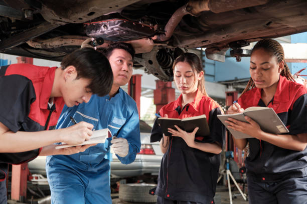 istock Supervisor engineer is teaching mechanic workers about car repair at a garage. 1768252980