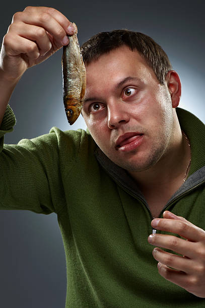 istock Portrait of hungry man staring at fish 176825498