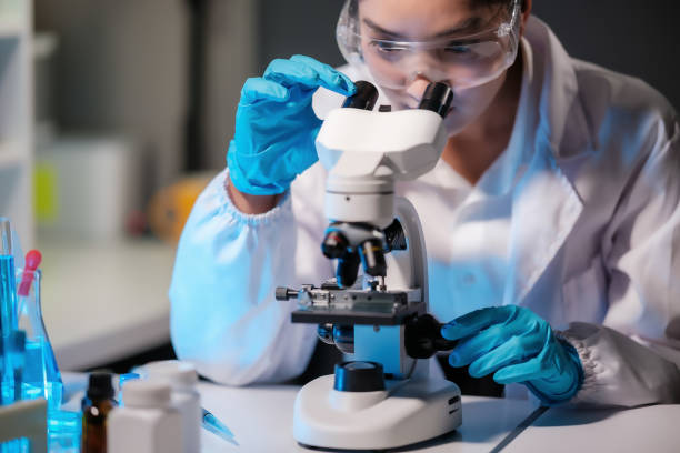 istock Asian female scientist looking under microscope, analyzes petri dish sample. specialists working on medicine, biotechnology research in advanced pharmacy lab, Medical development laboratory. 1768257290