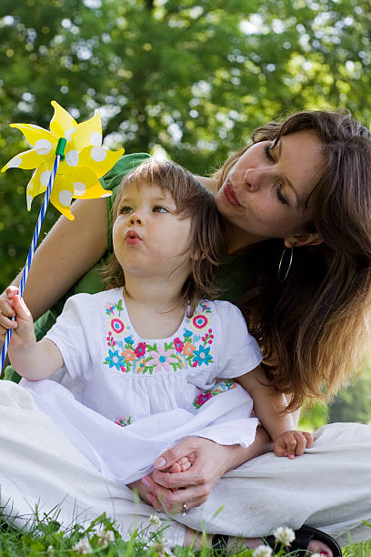 istock Mother and daughter playing in park 176826409