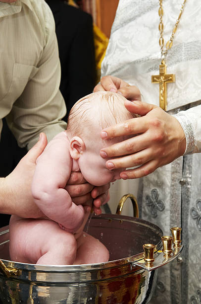 istock baby baptism with water in font 176826672