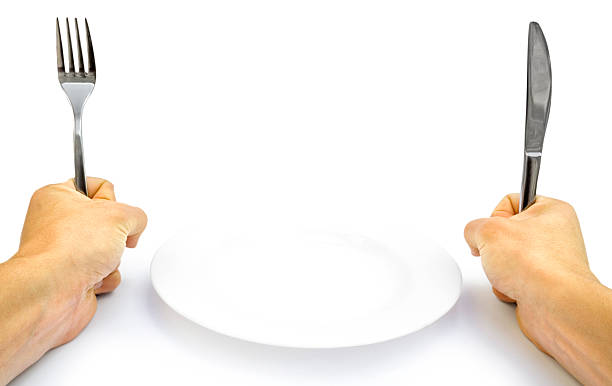 istock Hands holding upright cutlery and an empty plate  176826953