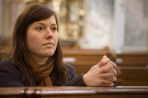 istock Praying Woman in a Church 176827521