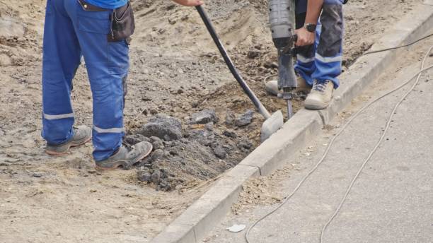 istock Roadworks Construction Site Conctractor Replacing Concrete Curb Brick using Shovel and Pneumatic Hammer 1768280531