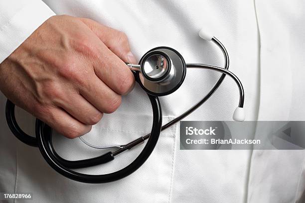 Doctor Holding Stethoscope Stock Photo - Download Image Now - Adult, Adults Only, Beauty