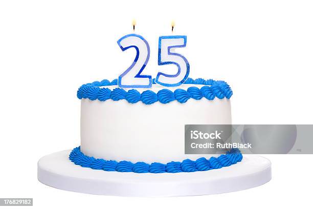 A White And Blue Iced 25th Birthday Cake With Lit Candles Stock Photo - Download Image Now