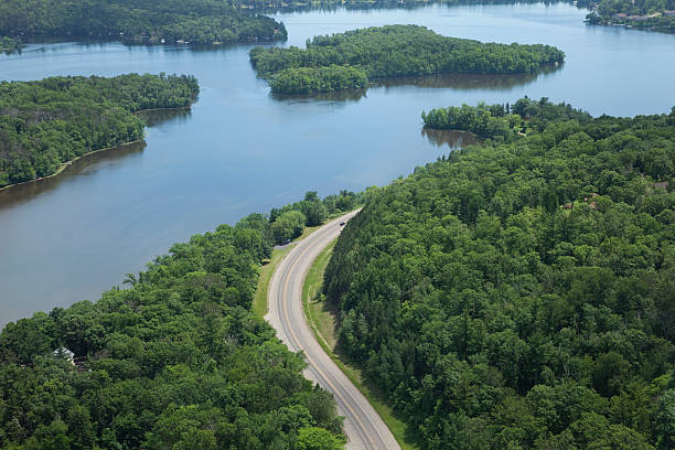 Aerial view of Mississippi River and curving road Aerial view of a curving road alongside the Mississippi River in Brainerd, Minnesota mississippi river stock pictures, royalty-free photos & images