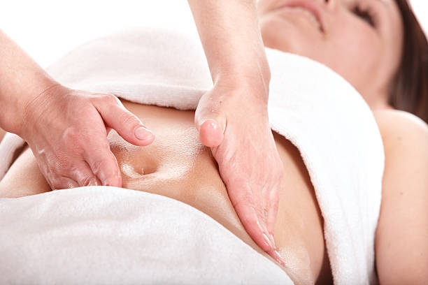 Girl having stomach massage. Body care. stock photo