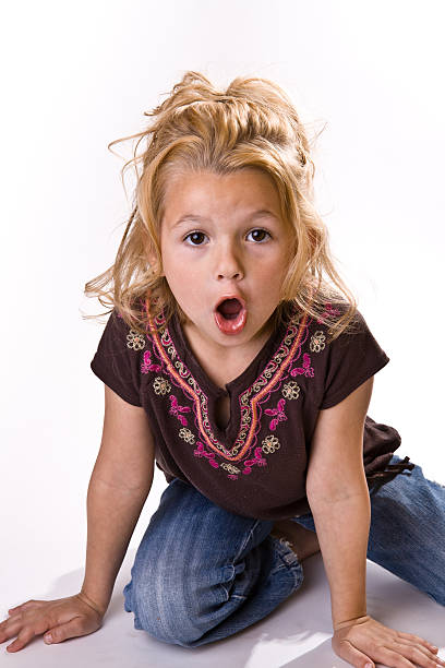 Adorable little girl with a surprised look on her face stock photo