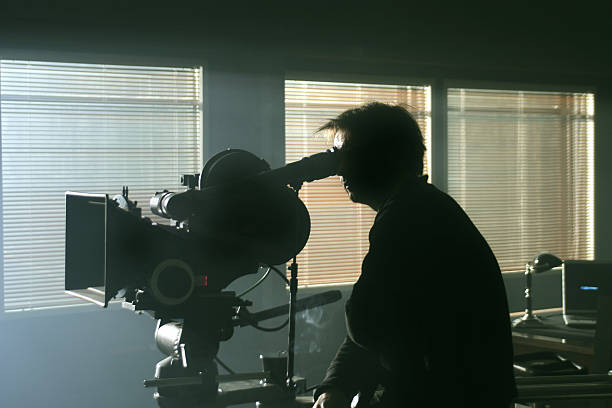 Silhouette of cameraman in the darkness stock photo