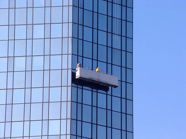 Window cleaner at a skyscraper facade stock photo