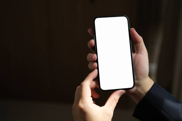 istock Close-up of male hand holding smartphone with white mockup on screen 1768304058