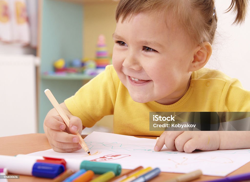 Little girl draw with felt-tip pen Cute little girl draw with felt-tip pen in preschool 2-3 Years Stock Photo