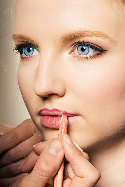 istock Close-up of a female applying make-up 176830828