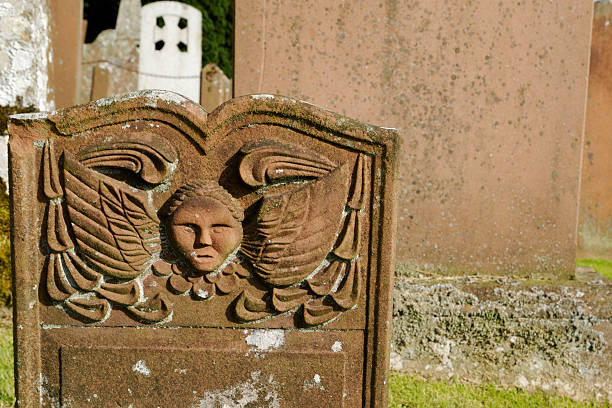 An old sandstone headstone in a rural Scottish cemetery. The date on the headstone was 1779. The headstone has been decorated with a carved angel.Old Headstones