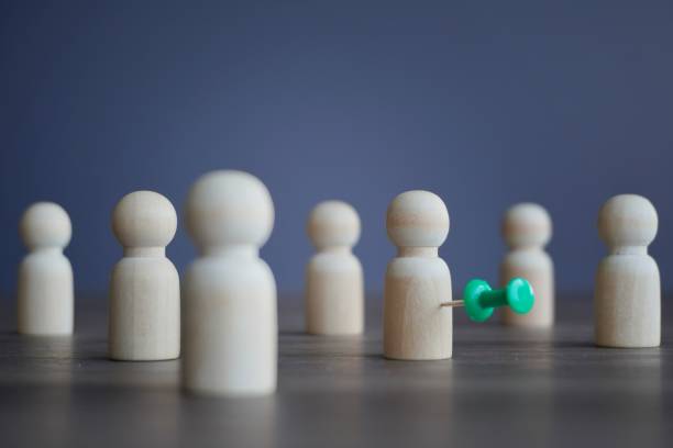 istock Wooden dolls and pushpin. 1768311550