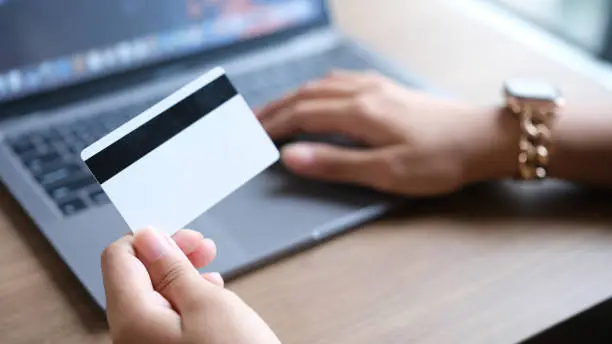 woman uses smart tablet computer and holds credit card with online shopping.Online payment concept.